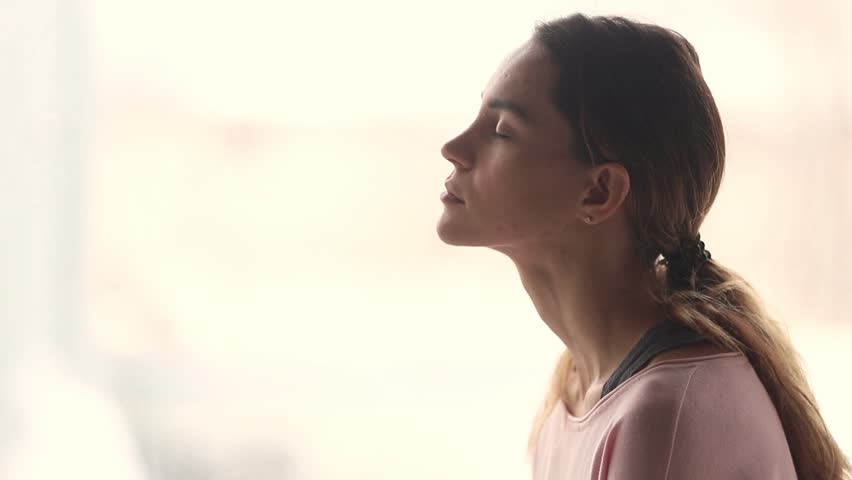 Calm young woman taking deep breath of fresh air relaxing meditating with eyes closed enjoying peace, serene tranquil girl doing yoga pranayama exercise feel no stress free relief, profile side view Royalty-Free Stock Footage #1028900276