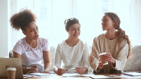 Three multiethnic girls students talking studying together at home african indian and caucasian friends discussing project assignment working in teamwork learning helping preparing for test exam - Powered by Shutterstock - Get 15% off with code: PIKWIZARD15