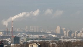 Glitch effect. Smoke from the pipes against the backdrop of the city. Ekaterinburg