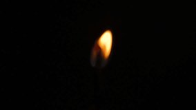 Macro clip of Burning match on dark background, matchstick igniting, Fire. Languages of flame. Night fire.