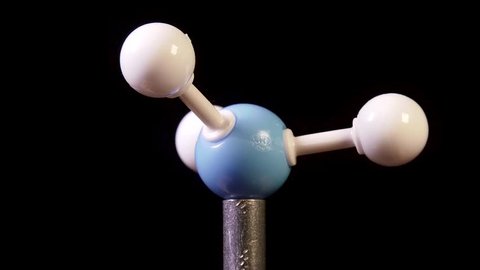 Ammonia NH3 molecule rotating on black background