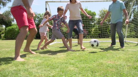 Multi-generation family playing football in garden together.Shot on Sony FS700 at frame rate of 25fps