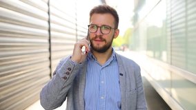 Portrait of businessman talking on the phone and smile