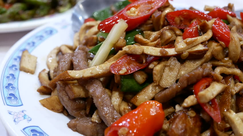 Motion of dried bean fried pork on plate inside restaurant with 4k resolution.