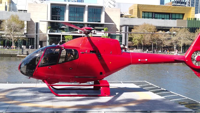 red private helicoper landing on platform in slow motion Royalty-Free Stock Footage #1028933237