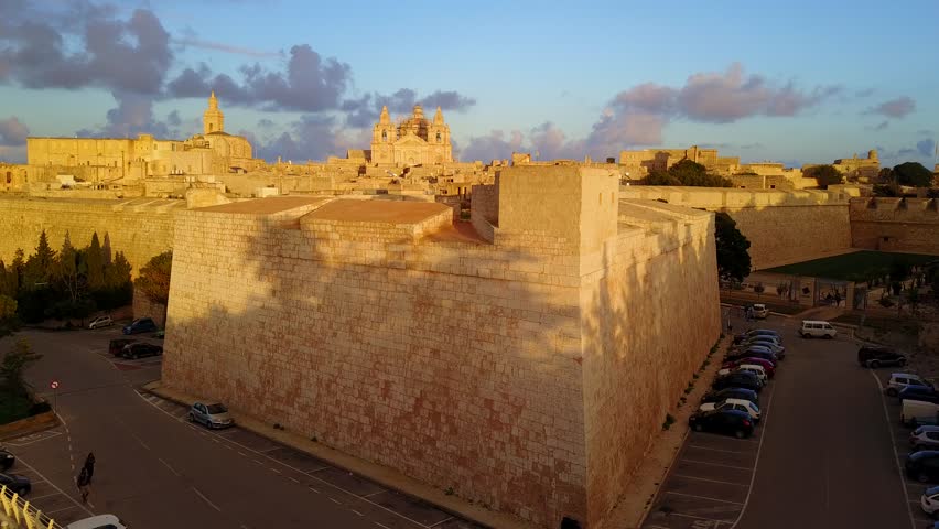Mdina fortified town in Malta surrounded by ramparts walls bastions aerial view on a winter evening before sunset 