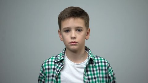 Preteen boy looking to camera, orphan social care, domestic violence prevention