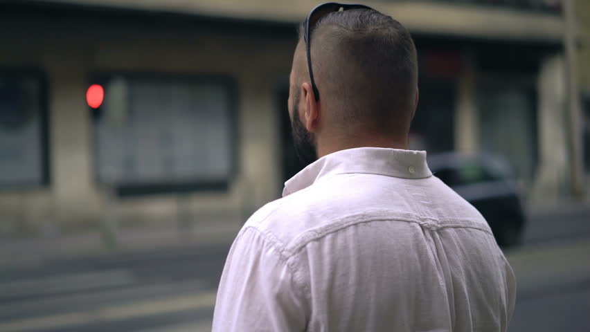 Young man crossing city street