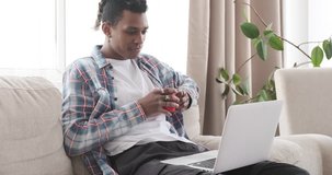 Man having snack while watching media content on laptop