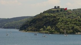 Historical Yoros fortress ( castle ) also known as Genoese Castle and Turkish flag in Bosporus, Istanbul. The castle is located at the meeting point of Black Sea and the Bosporus.
