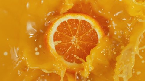 Super Slow Motion Shot of Orange Slices Splashing to Orange Juice at 1000fps.