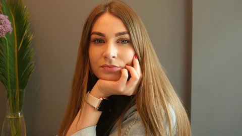KHERSON, UKRAINE - MAY 03, 2019: Young Cute Woman Portrait with iWatch on a Wrist