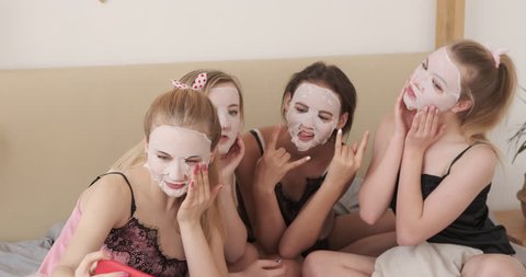 Teen girls applying moisturizing facial tissue mask
