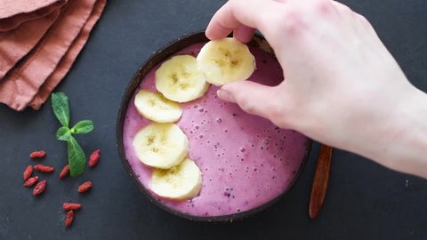 Preparation of acai smoothie bowl in time lapse. Healthy food. Top view