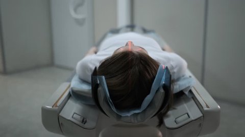 Female Patient On The Ct Or Mri Scanner Machine During X-Ray Process,
