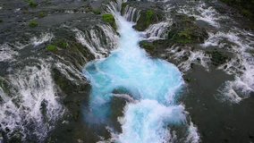 Drone aerial view of Bruarfoss waterfall landscape in Brekkuskogur, Iceland. Bruarfoss waterfall is the famous waterfall attracting tourist who visit route of Iceland Golden Circle.