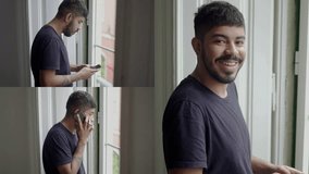 Collage of serious Caucasian man with beard in black T-shirt standing at window at home, talking and texting on phone, looking at camera, smiling. Communication, lifestyle concept