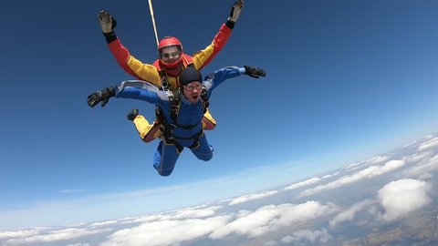 Tandem skydiving. Two men are flying in the sky.