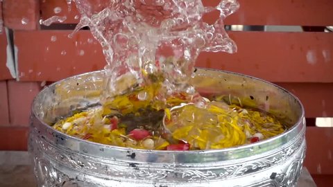 Roses, jasmine flowers and marigold flowers in a water bowl that is filled with aromatic water, using watering to bless the Thai culture.