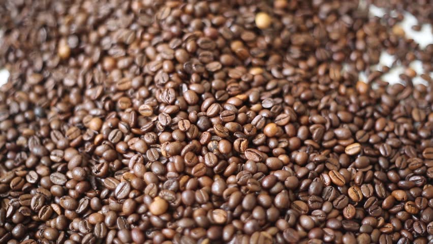 Brown roasted coffee beans is mix of arabica and robusta. Selected focus. Beautiful bokeh