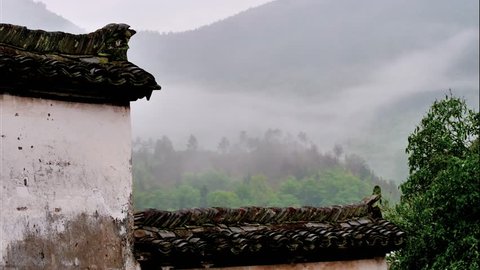 Time lapse of Wuyuan village in morning, beautiful clouds moving up and down in mountains, amazing rural landscape, view from traditional Hui style windows.
