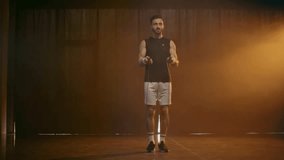 Full length view of sportsman in white shorts jumping with skipping rope