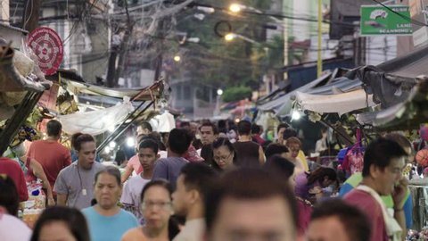MANILA, PHILIPPINES - CIRCA JANUARY 2017: A slow motion shot of allot of people walking in a street market in Manila