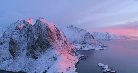 Aerial: Pick Sunset Reflecting Off Snowy Mountain in Lofoten, Norway