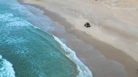 Aerial: Off-Road Vehicle Driving on the Beach in Caesarea, Israel