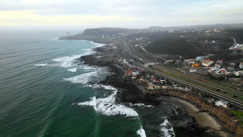 Aerial Right: Bustling Highway On Edge Of Ocean And Town in Baja Malibu, Mexico