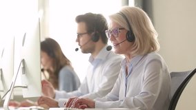 Older mature business woman wear wireless headset working in customer service support office, senior aged call centre agent operator using computer consulting client with request or complaint - Powered by Shutterstock - Get 15% off with code: PIKWIZARD15