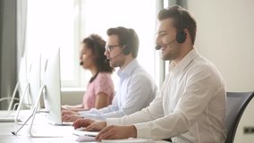 Male call center agent wear wireless headset consulting online customer solving complaint use computer, business man operator talking working in service helpline support office with professional team - Powered by Shutterstock - Get 15% off with code: PIKWIZARD15