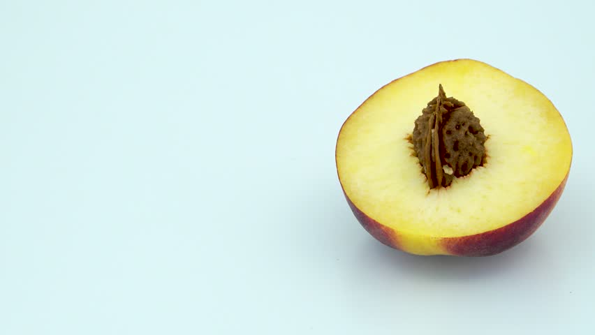 Peach half with seed frame right in 4k 3840 x 2160 Rotating Loop-able 360 Degree Rotation