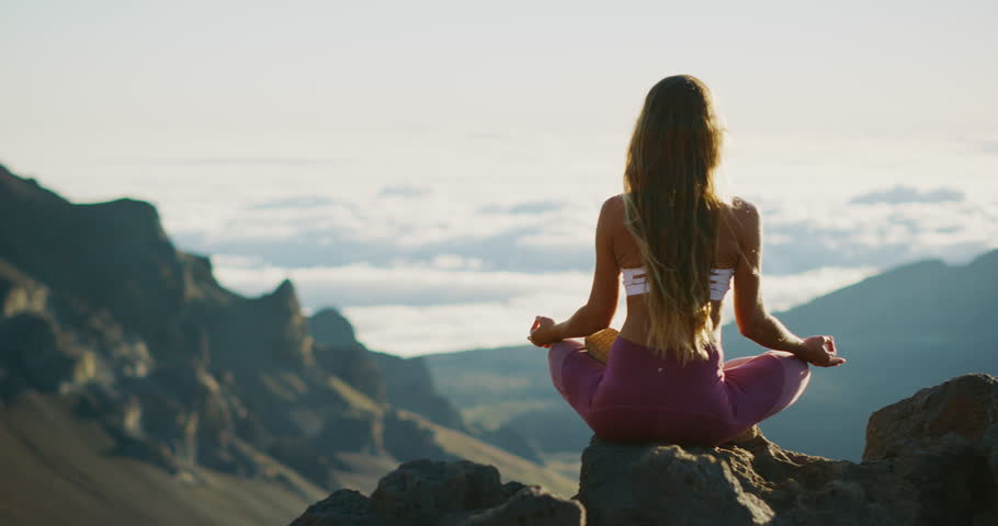 Young athletic woman meditating on the top of a mountain, zen yoga meditation practice in nature Royalty-Free Stock Footage #1029056165