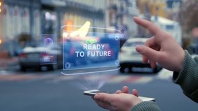 Female hands on street interact with HUD hologram with text Ready to future. Woman uses the holographic technology of future in smartphone screen on background of evening city - Powered by Shutterstock - Get 15% off with code: PIKWIZARD15