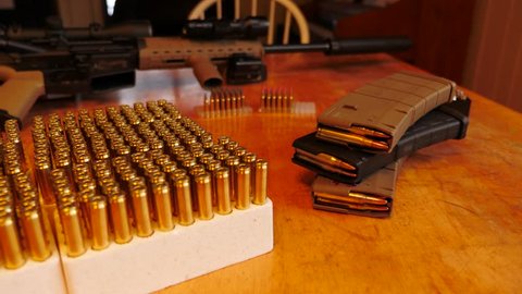 Ammunition with a military style assault rife in the background