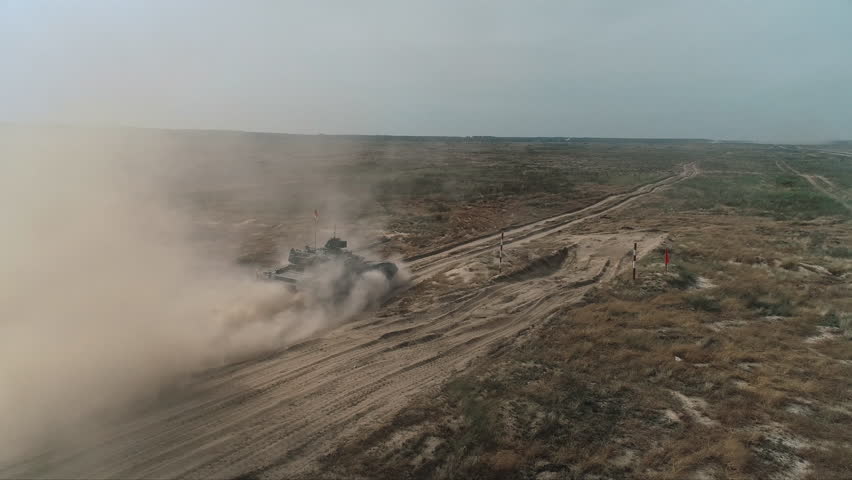 Aerial View Military Army Tank Shooting. Heavy Combat Fighting Vehicle Training in Sand Back View. Battlefield Advanced Technology/ Drone Shot Footage 4K (UHD)