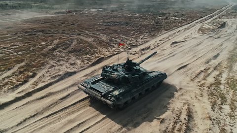 Military Army Tank Shooting Aerial View. Back View Armoured Combat Fighting Vechicle Shooting in Sand. War Battle Technology Concept. Drone Shot Footage 4K (UHD)