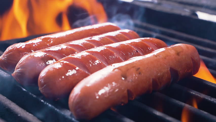 Barbecue Grill Cooking Healthy Low Fat Lean Meat Classic Takeaway Sausages Meal. Slow motion of hot dogs being cooked on an outdoor grill, being turned using a tongs. Making a picnic. Close up Royalty-Free Stock Footage #1029082481