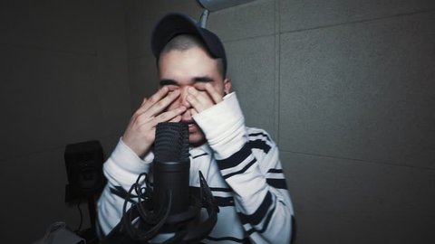 Young Korean Man singing/rapping in a music studio in Seoul, South Korea