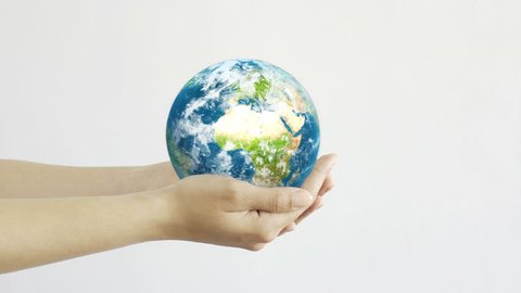 Woman holding the Planet in hands. Young adult hands holding the globe on white background. Conservation concept.
