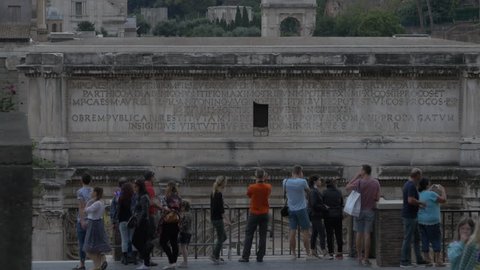 Italy, Rome - September, 2016: Evening view of tourists admiring the Arch of Septimius Severus, in Rome.