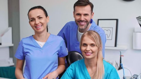 Portrait of three, smiling dentists in dentist's clinic