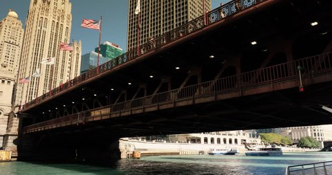 Chicago, Illinois, USA - September 23, 2018: Ferry boat passes under the DuSable Bridge over the Chicago River in downtown Chicago Illinois USA during a summer day