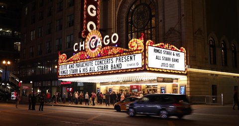 Chicago, Illinois, USA - September 24, 2018: People and traffic gather by the Chicago Theatre on North State Street in the Loop area of Chicago, Illinois USA.