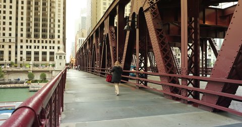 Chicago, Illinois, USA - September 25, 2018: Cars and people walk across the LaSalle Bridge over the Chicago River in downtown Chicago Illinois USA during a summer day
