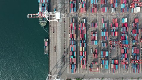 Logistic business or transport concept : Aerial top down view over import export port of Thailand with many stacks of cargo container rows and big cranes.