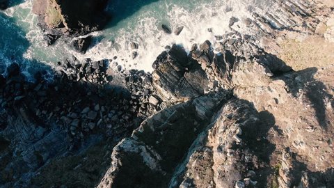 Aerial shot of a rocky cliff on a sunny day in Holyhead, Wales, United Kingdom.