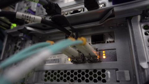 RUSSIA, MOSCOW - May 08, 2019: Optical server. Commutator. flashing lights. Optical fiber. Severs computer in a rack at the large data center. Video contains vibrations and flicker Editorial.