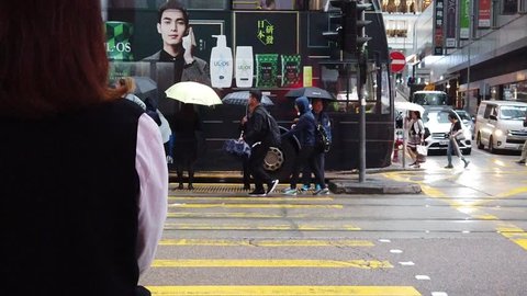 Hong Kong, China, May 08, 2019: slow motion of Busy streets of Des Voeux Road Central District in Hong Kong. Streets crowded with people shopping at the raining day